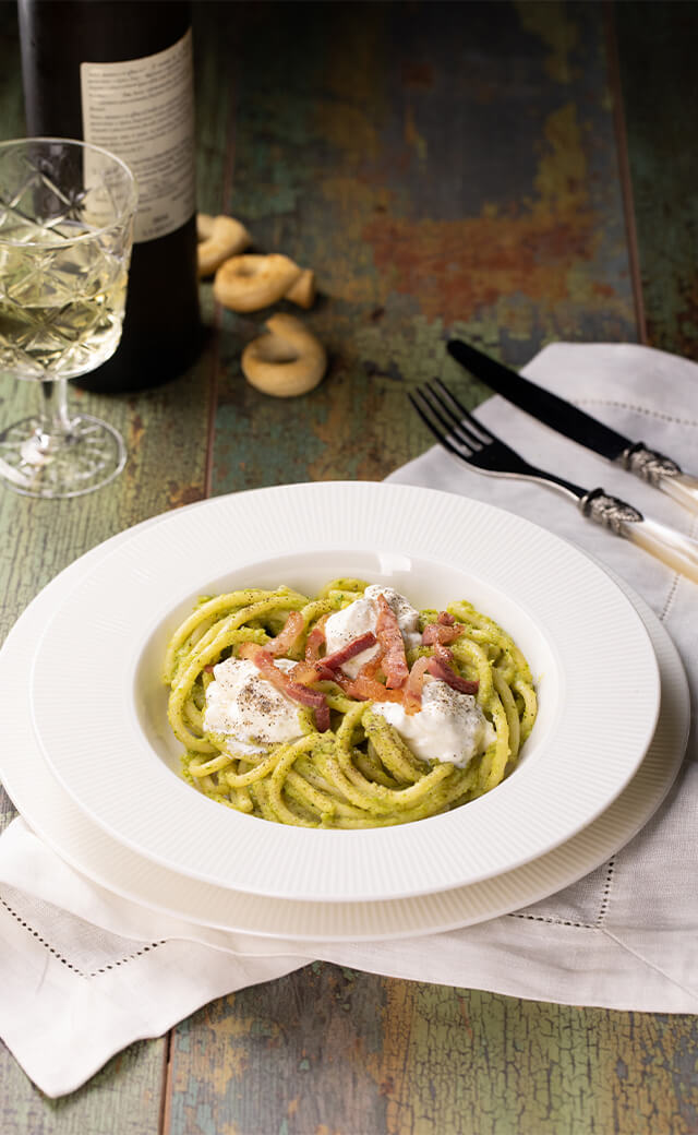 Bucatini con crema</br>di broccolo, stracciatella e pancetta